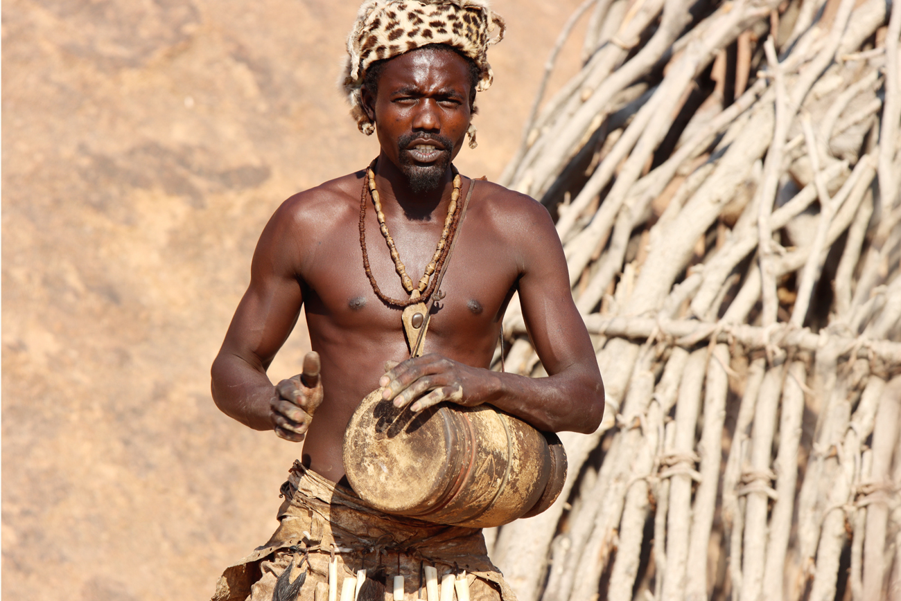 Fotografia tańczącego mężczyzny z plemienia Damara zrobiona w Damaraland w Namibii, autorstwa Ani Wilanowskiej